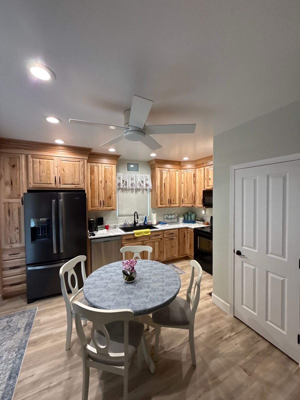 Kitchen with completed recessed lighting and ceiling fan installation