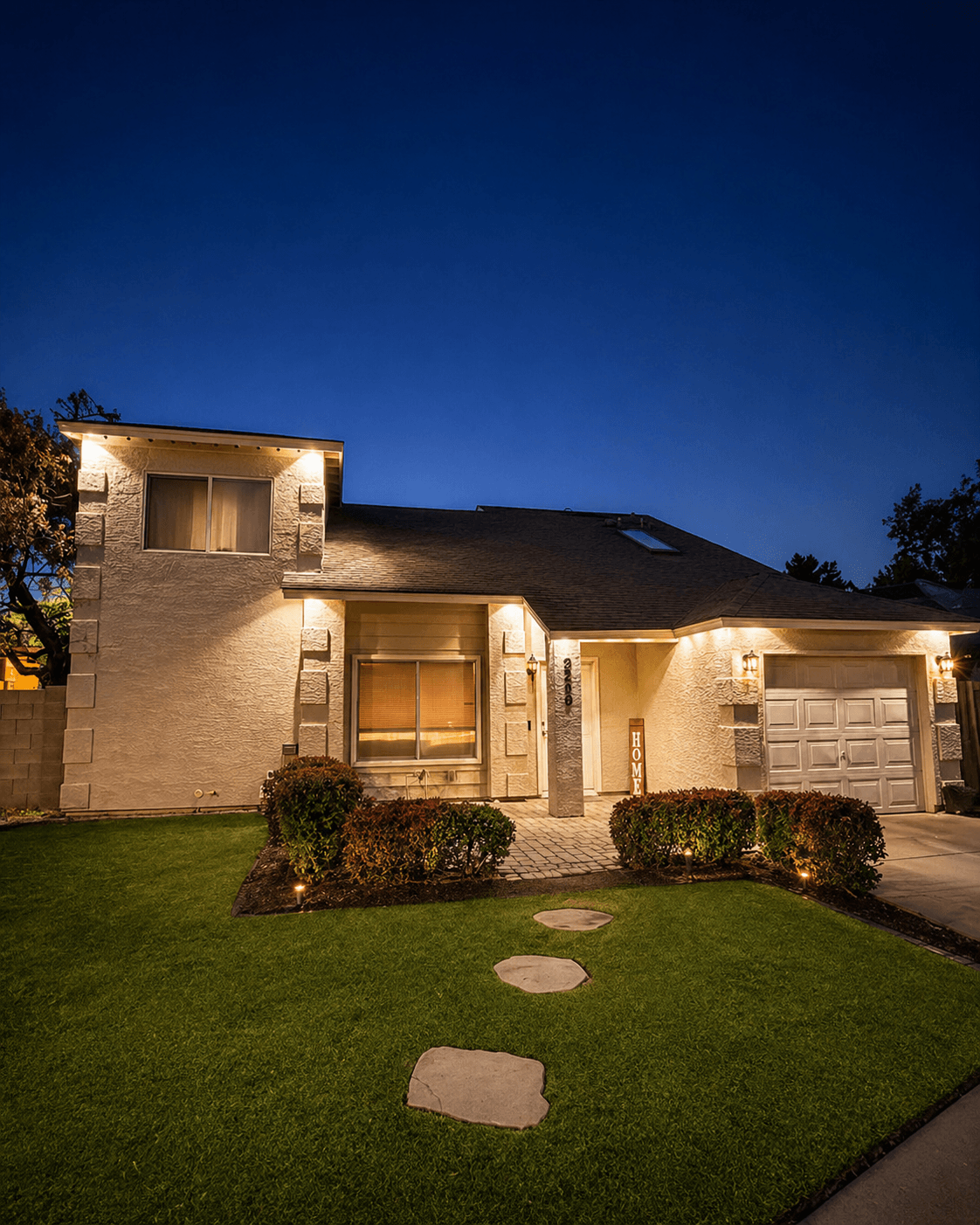 Exterior lighting illuminating a residential home at night